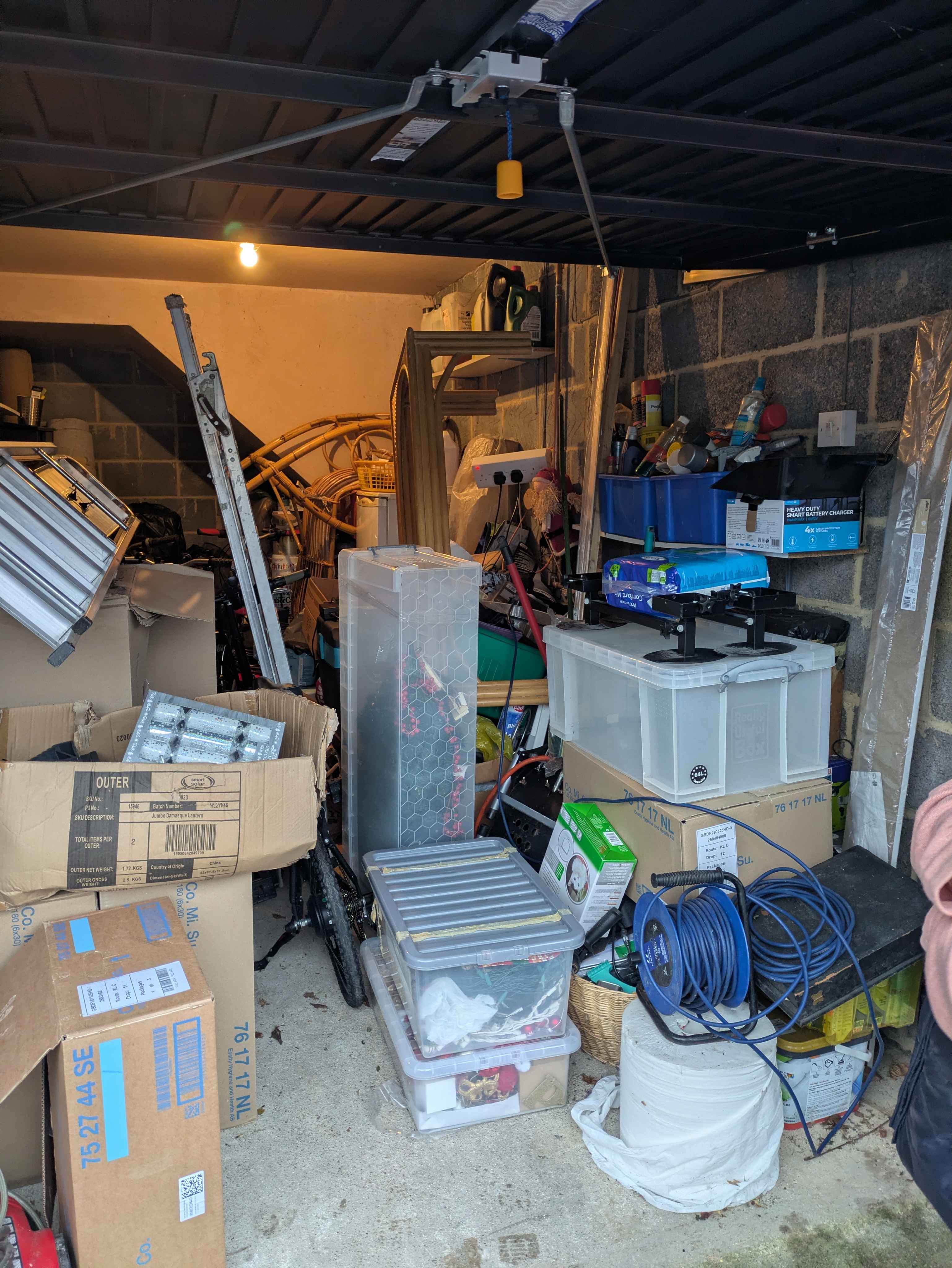 A typical St Neots garage packed with years of accumulated contents — exactly the kind of job Hunt 'n' Haul clears