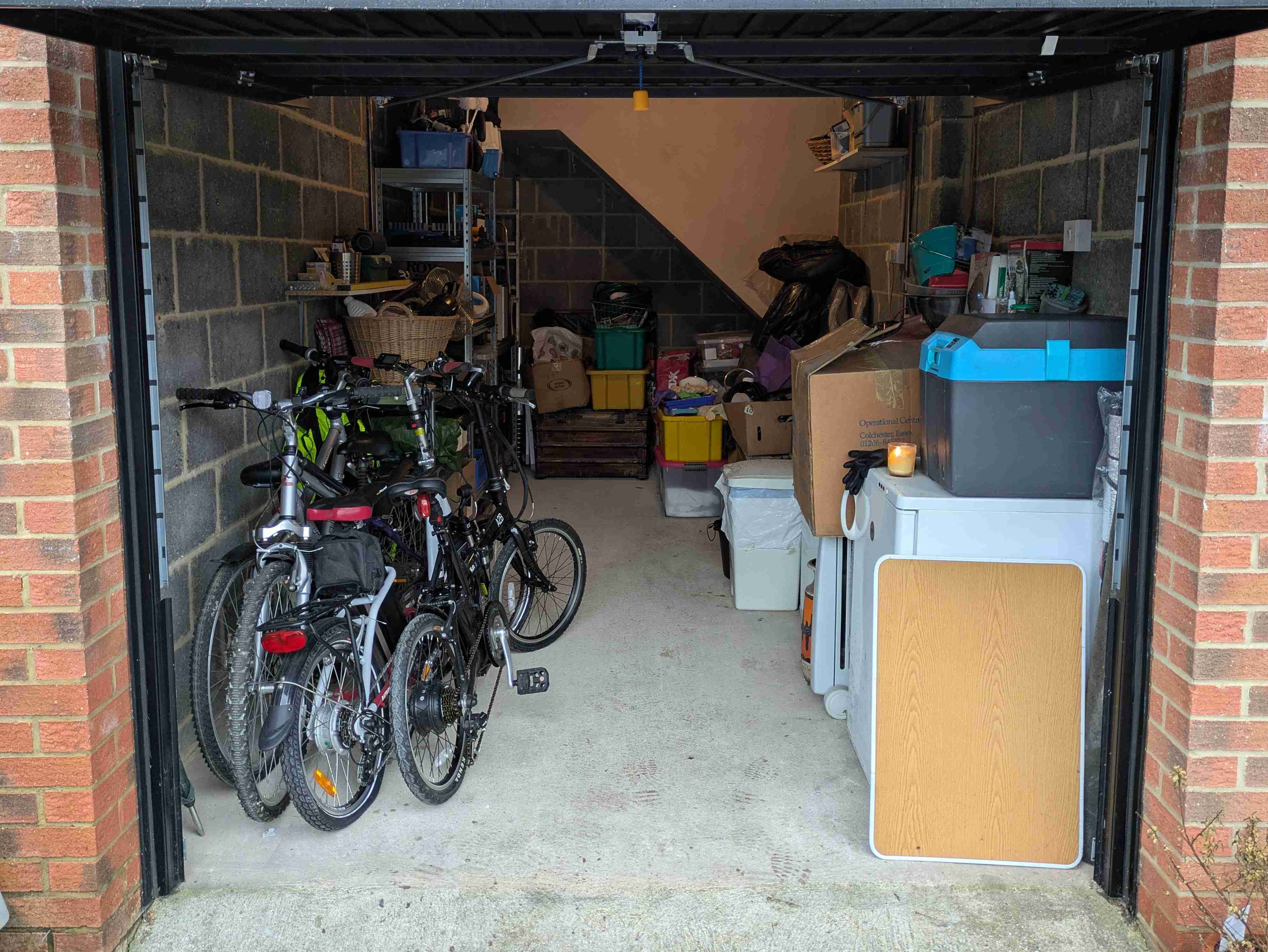 The same garage cleared down to the family bikes, walls and floor visible again