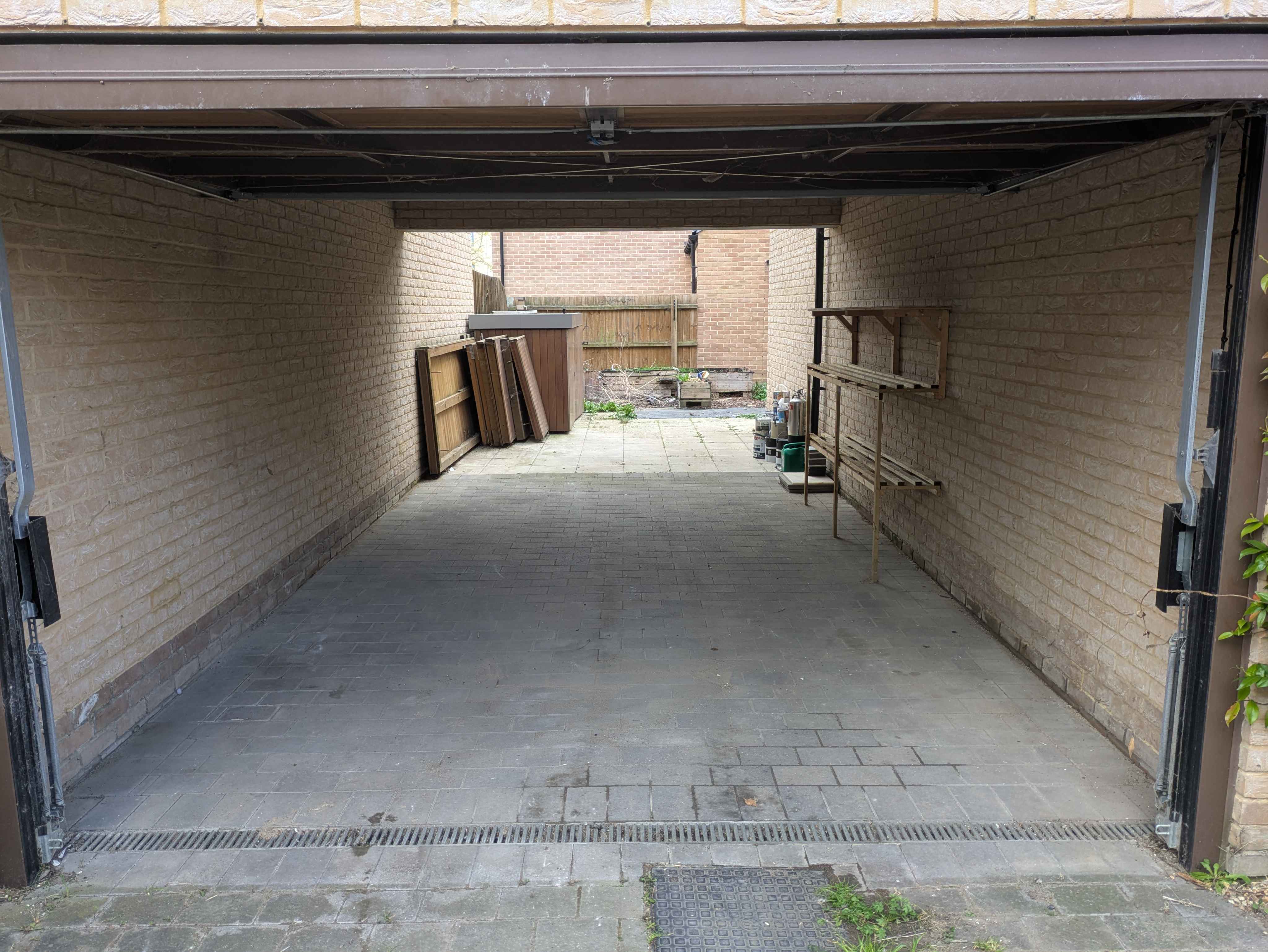 The same garage swept clean, empty floor and walls, ready to be used again